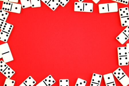 White domino pieces on red background with a copy-space for textの写真素材