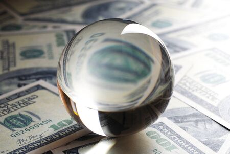 Transparent crystal ball on 100 dollar banknotesの写真素材