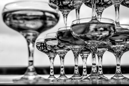 Group of empty champagne / wine glasses in black and white.の写真素材