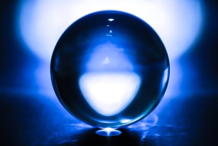 Transparent crystal ball in abstract blueの写真素材