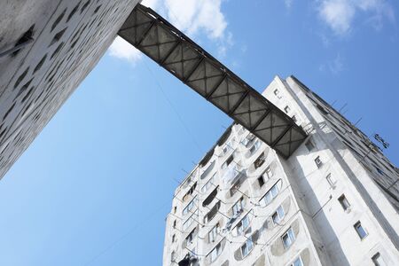 Post soviet architecture in Georgia. Two blocks of flats linked with a metal bridge.の写真素材