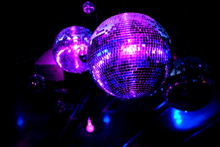 Shiny disco balls in blue and purple light.