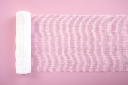 Sterile bandage on a pink background. White sterile gauze.の写真素材