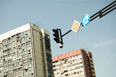 Traffic light and road signs with multistory buildings on the background.の写真素材