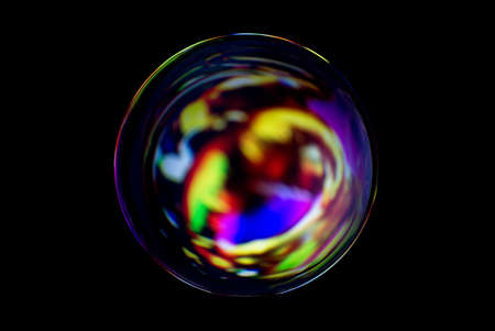 Blurry image of a shiny crystal ball with abstract blurry colorful pattern. Abstract lensball in blur.の写真素材