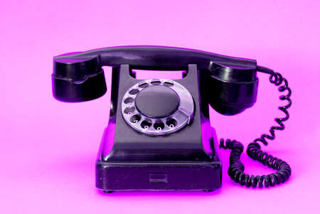 A vintage dial phone from the 80s in abstract vivid colors.  Retro style landline telephone art.の写真素材