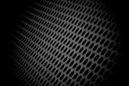 Abstract surface with round holes in a low key. Round holes background in black and white.の写真素材