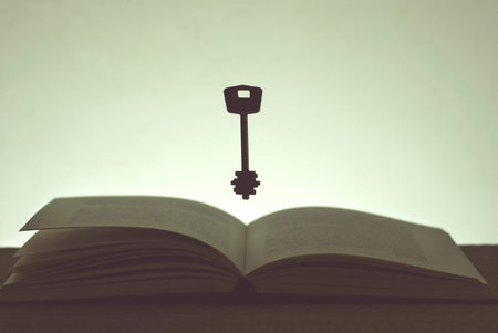 Open book and a flying key in the dark