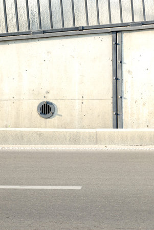 Concrete structure detail and a part of a highway. Concrete wall texture with a round ventilation...