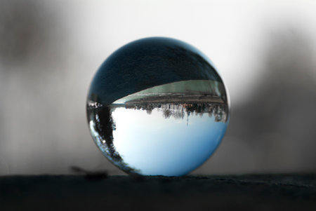 A riverside highway view through a lens ball. Glass ball with inverted view.の写真素材