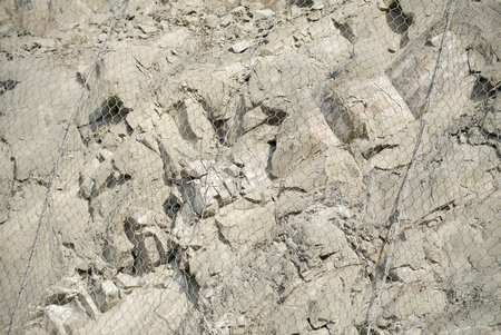 Metal protective mesh on a cliff. Protective grid.の写真素材