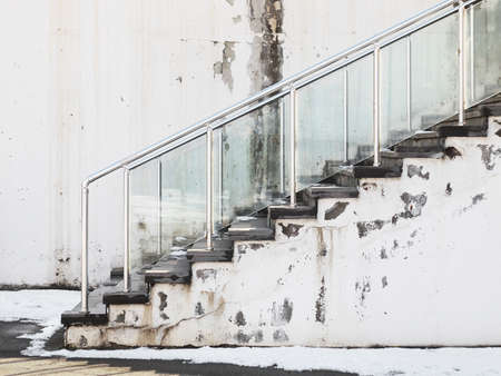 A staircase leading up with some snow left on the groundの写真素材