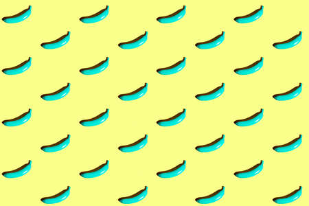 Minimal repetitive patter made of blue bananas on yellow background.の写真素材