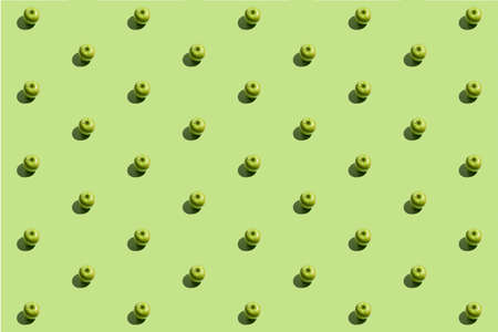 Minimal repetitive pattern made of green appes on green backgroundの写真素材