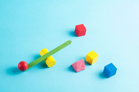 Minimal layout with a green and yellow swing scale and geometric figures on blue background