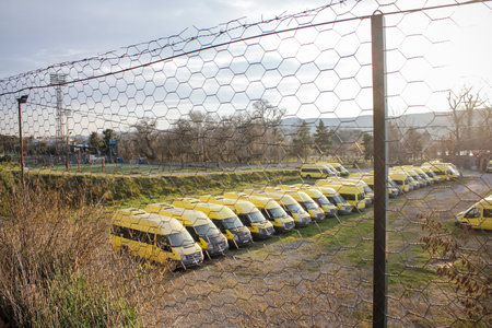 Rustavi, Georgia. December 11, 2021. Parking lot with yellow vans.のeditorial素材
