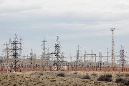 Evening scene with electricity pylons in a deserted area.
