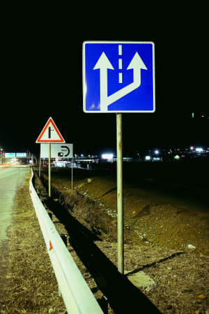 Road sign at night. Night scene with a traic signpost.の写真素材