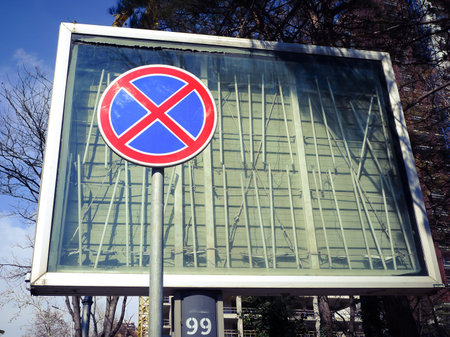 Red and blue regulation sign in the street.