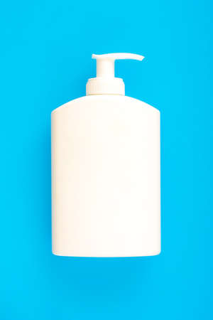 White blank plastic bottle on blue background.の写真素材