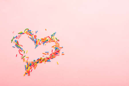 Simple concept flat lay with a heart made of sugar sprinkles.の写真素材