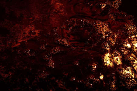 Abstract black and yellow background with bubbles. Black liquid surface with bubbles.の写真素材