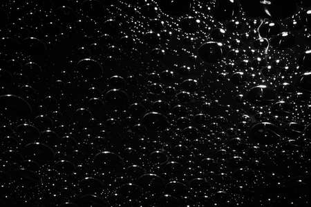 Abstract black background with bubbles, Bubbles texture with chaotic pattern in black and white.の写真素材