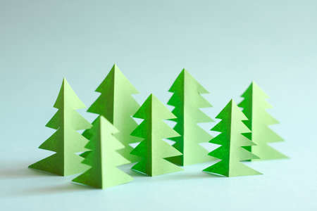 Green paper forest on blue background. Paper trees.の写真素材