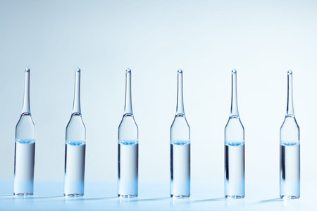 Six medicine ampules standing in a row. Blue monochrome medicine concept image.