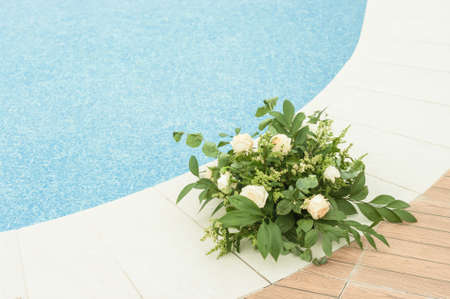 Beautiful decorative bouquet of tiny flowers by the swimming pool.の写真素材