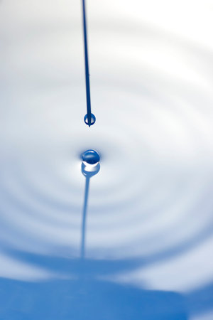 Macro image of a syringe needle with droplet.