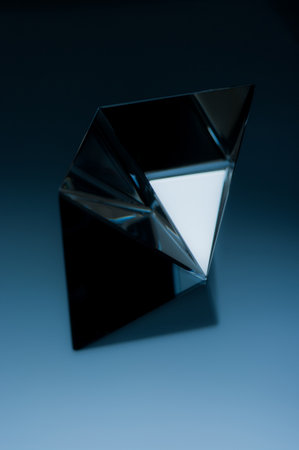 Abstract geometric object on dark blue background. Abstract minimalist image of a shiny object.の写真素材