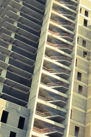 Unfinished residential building facade. Modern building construction.