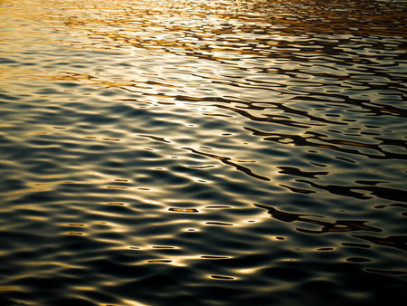 Beautiful sea with warm sunlight reflections during the sunset.の写真素材