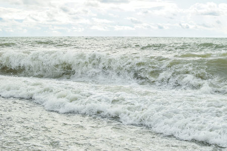 Big waves in the sea. Beautiful sea with splashes under the bright morning sunlight.
