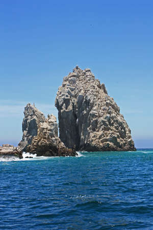 Large rock formation jutting up from the ocean off shore from Mexico.の写真素材