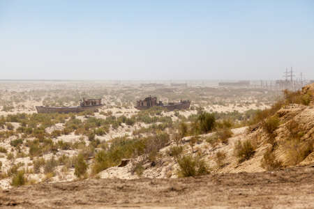 Rustic boats on a ship graveyards on a desert around Moynaq, Moynoq or Muynak - Aral sea or Aral lake - Uzbekistan, Central Asiaの写真素材