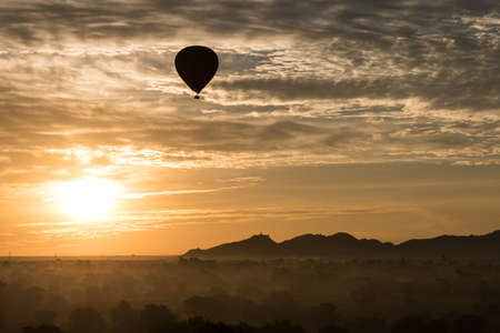 A Hot air balloon over plain of Bagan in misty morning, Myanmarの写真素材