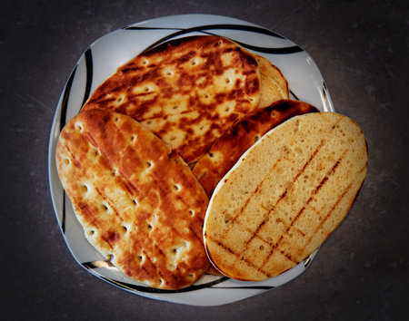 Bread toasted on a gas grill.The tortillas lie on a plate.
