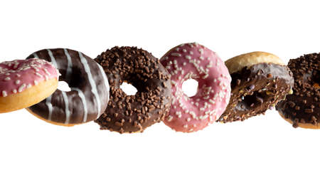 Levitating a variety of donuts on a white backgroundの写真素材