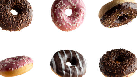 Levitating a variety of donuts on a white backgroundの写真素材