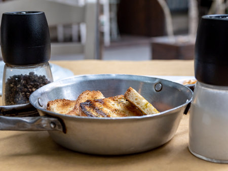 A slice of toasted bread in a bowl with sauces in the background. high quality photoの写真素材