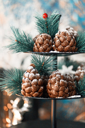Christmas tree cone-shaped cookies with chocolate flakes with powdered sugar, a delightful homemade dessert for the New Year. These chocolate pine cone-shaped shortbread cookies with sweet snowの写真素材