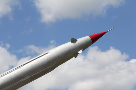 missile with a red tip and peaceful blue sky