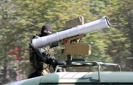 defender in a mask with a heavy weapon during a military paradeのeditorial素材