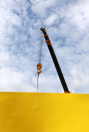 boom crane and a blank sheet of paper on the background of the skyの写真素材
