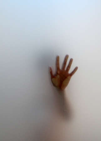 silhouette emerging from the fog with an outstretched handの写真素材