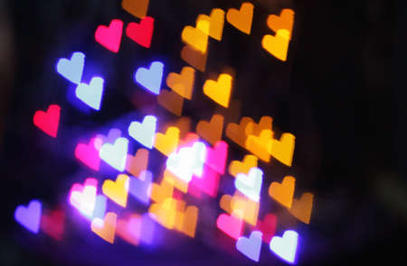 background color glowing with love hearts for holidayの写真素材