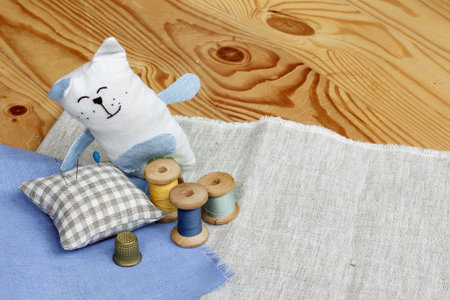 soft cloth cat with needlework and embroidery items
