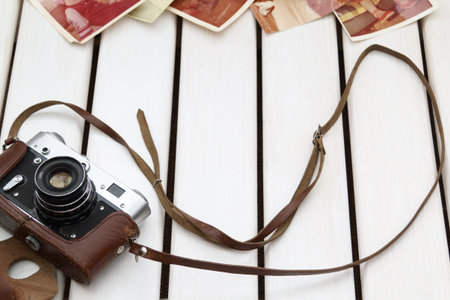 wooden background with the camera and old photos